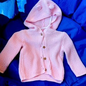 Knitted sweater with a hood